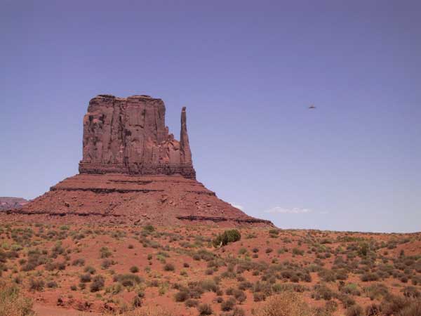 Red single rocks in flat desert