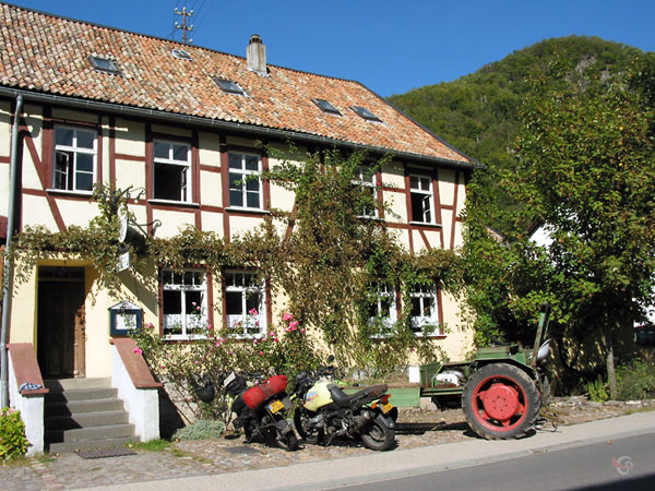 Half-timbered building, a tractor and two BMW GSses