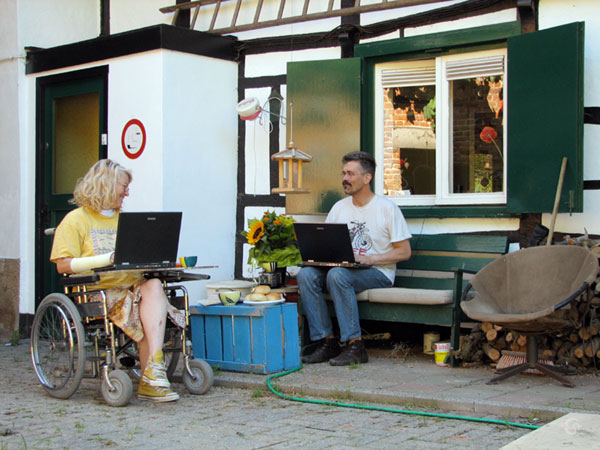 In the wheelchair, with notebook, in the garden