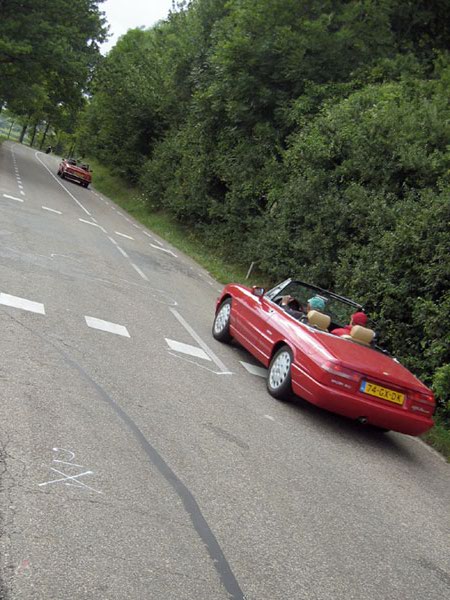 Road with white cross on the wrong side of the road