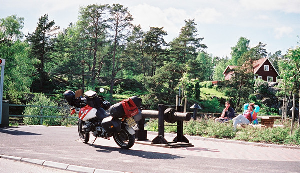 Red and white R1100GS and a wooden house