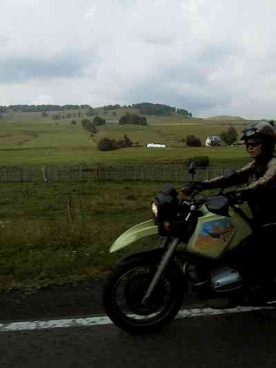 Sylvia on an R1100GS, view of a green valley
