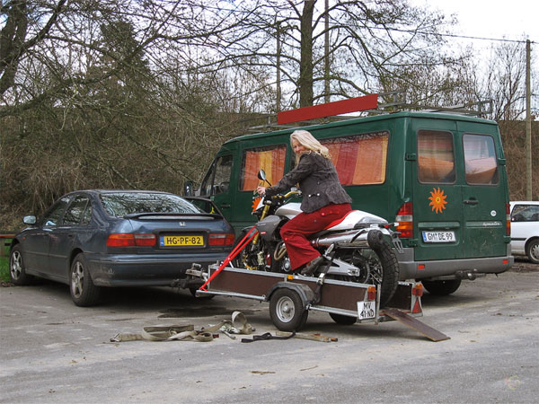 Sylvia seated on the Derbi Mulhacen, on a trailer