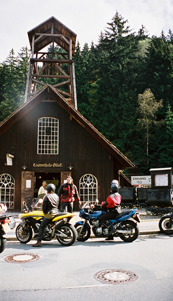 Wooden building and yellow Bimota Mantra