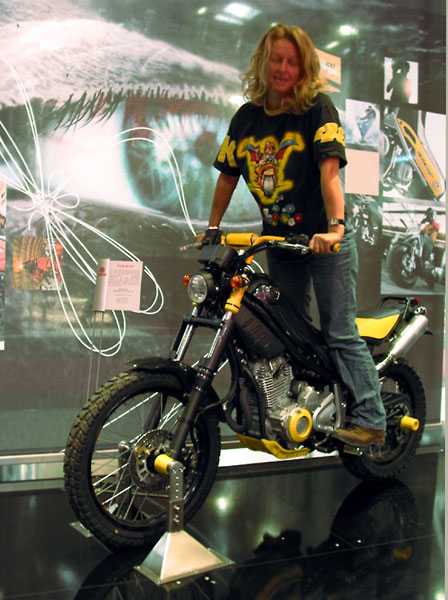 Sylvia posing on a small black and yellow bike