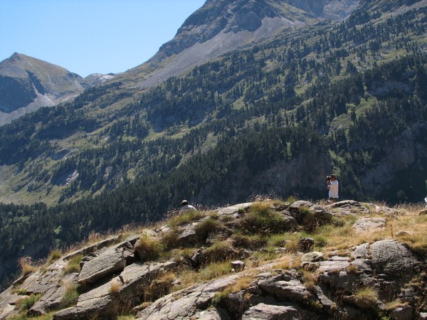 Man nforogtafeert op rots in berglandschap