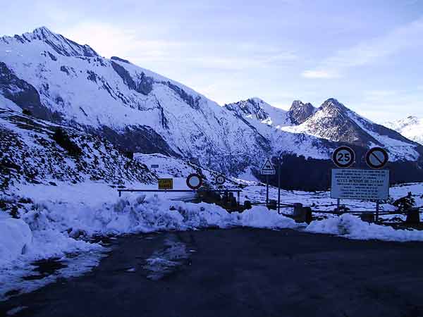 Signs of a closed pass, and snow all over the place