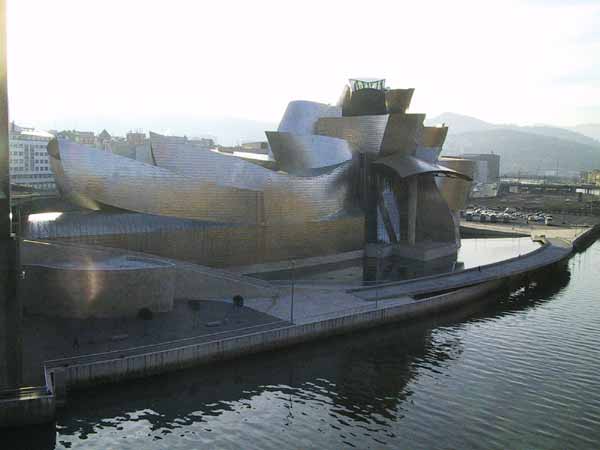 A ship-like structure, on land but next to the water, in metal sheets