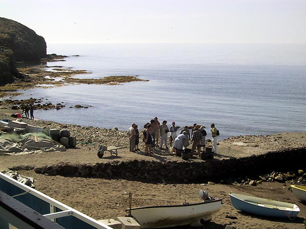 Bay with fishermen, rocky caost