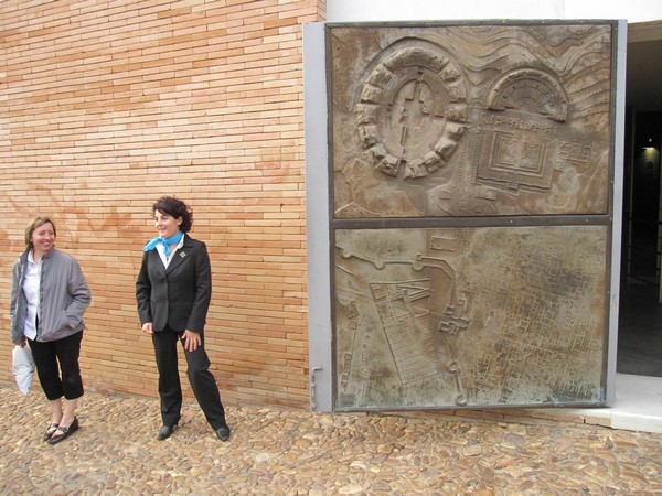 Vrouwen voor muur en deur met relief