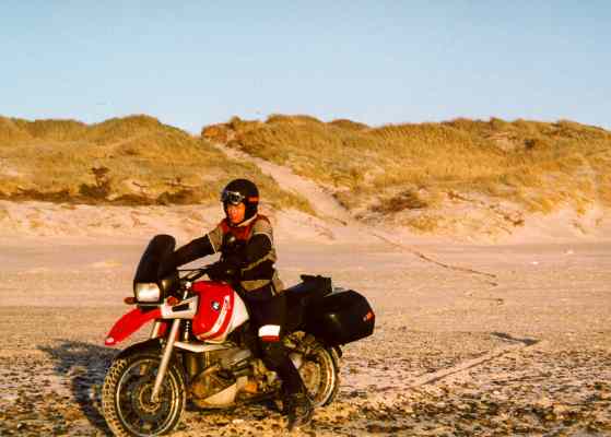 Sylvia on her motorcycle, on the beach