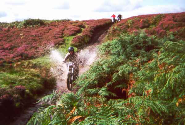 Motorcycle splashing through water