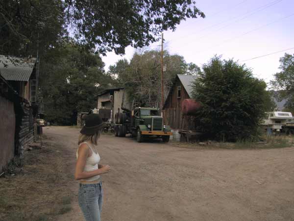 Karin on an unpaved road, a truck, some gardens