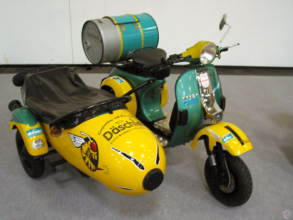 Vespa met zijspan in groen en geel