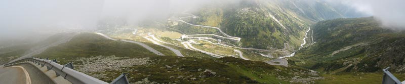 Tussen de mist door: naar beneden haarspeldende weg