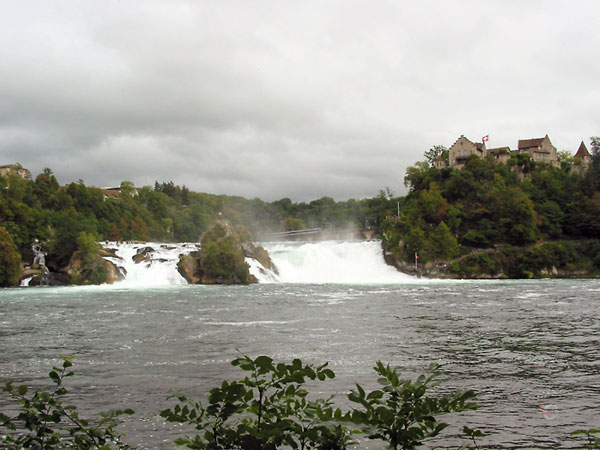 Rechts een huis op een rots, daarnaast de waterval