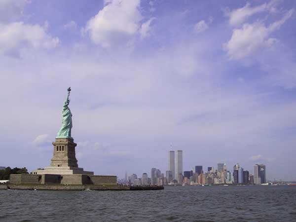 Statue of Liberty, seeb from the water, with the Manhattan skyline as a background