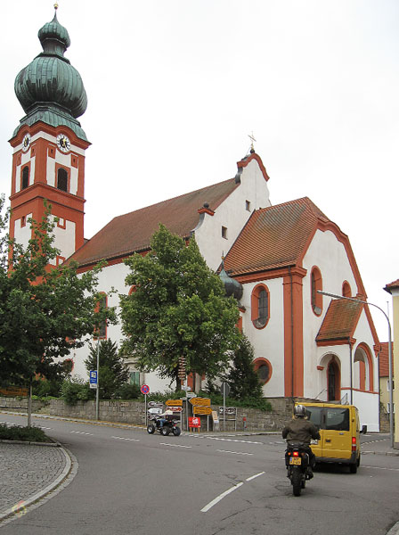 Rood gekleurde kerk met uivormige toren