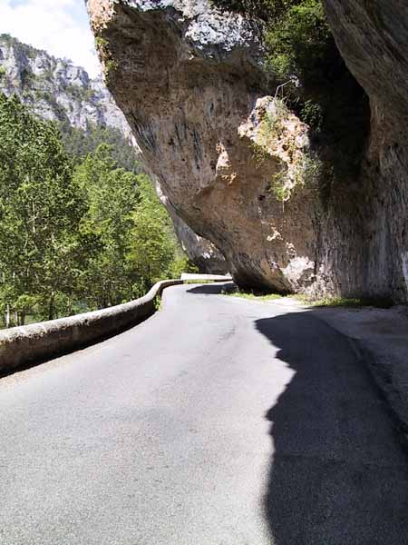 Road alongside overhanging rocks