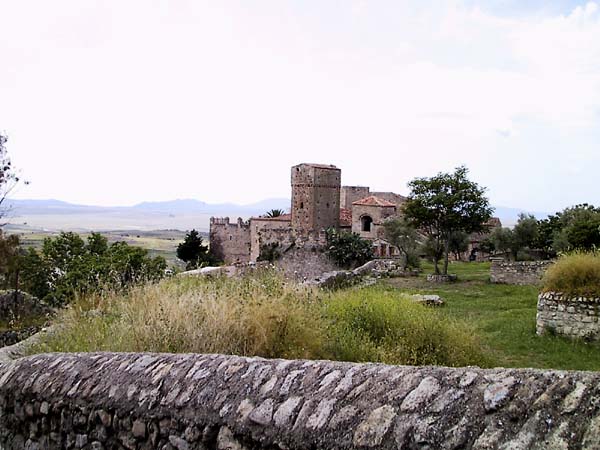 Muur met wat ruines en oude gebouwen in de verte