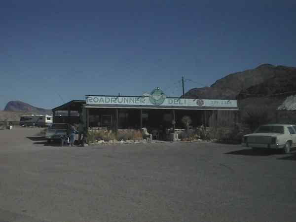 Low building with sign: the Roadrunner Deli