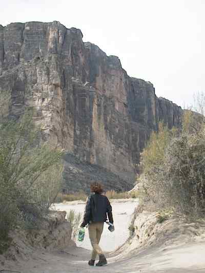 Sandy path, vertical rock in the distance