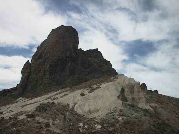 Black mountain, white rock on the foreground