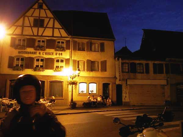 Sylvia with helmet in front of a timbered house